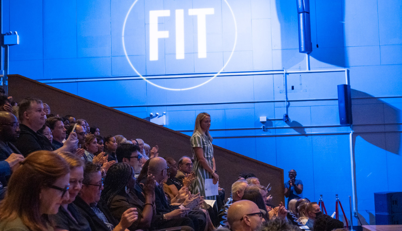 new faculty member stands up to be recognized at convocation 