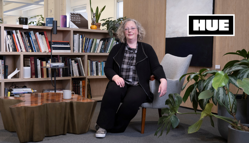 Hilary Catterall sits in a chair in her office