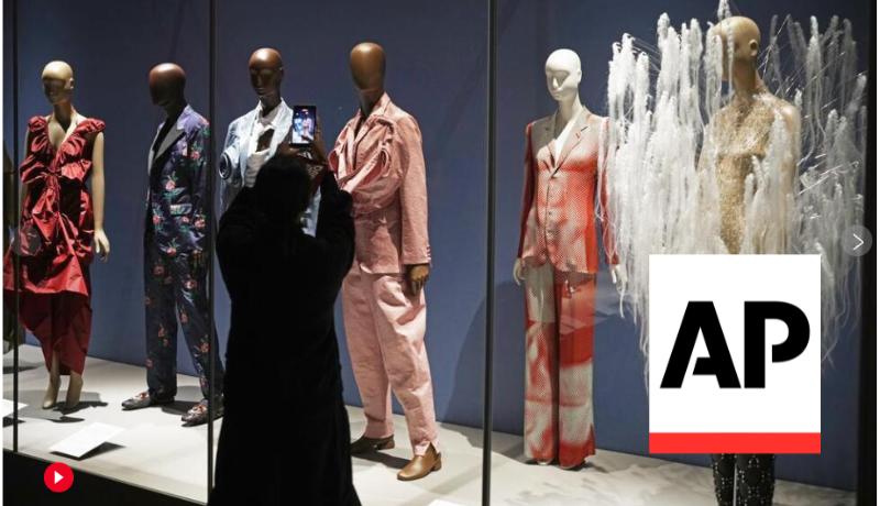 exhibition view of Dress, Dreams, and Desire featuring a number of mannequins; AP logo
