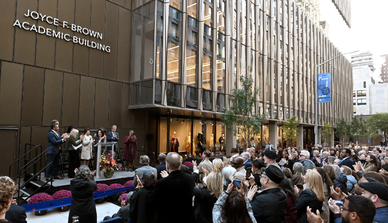 people stand outside FIT's new academic building for the ribbon cutting ceremony and naming of it as the Joyce F. Brown Academic Building