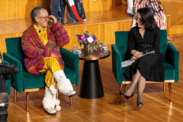 Amy Denet Deal and Dr. Joyce F. Brown sitting in chairs onstage at the Native American Heritage Month event