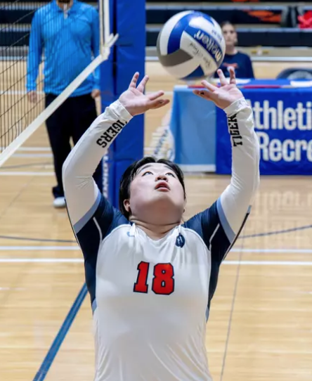 Juun Shin on the volleyball court just about to set a ball