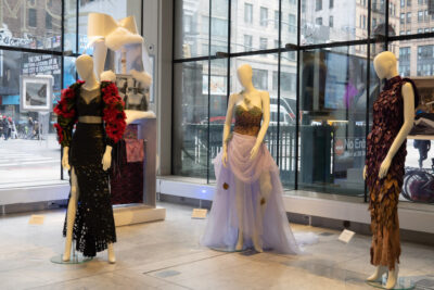 several dresses on mannequins in the FIT Art and Design Gallery