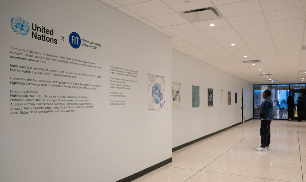 woman looks at the UN scarves exhibition