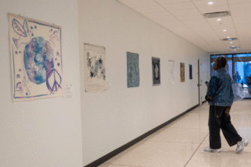 woman looks at the UN scarves exhibition