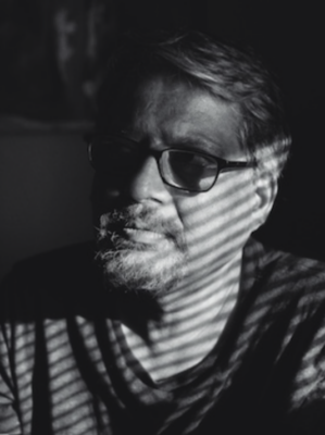 Photographer and FIT professor Praveen K. Chaudhry in a chiaroscuro photograhic portrait.