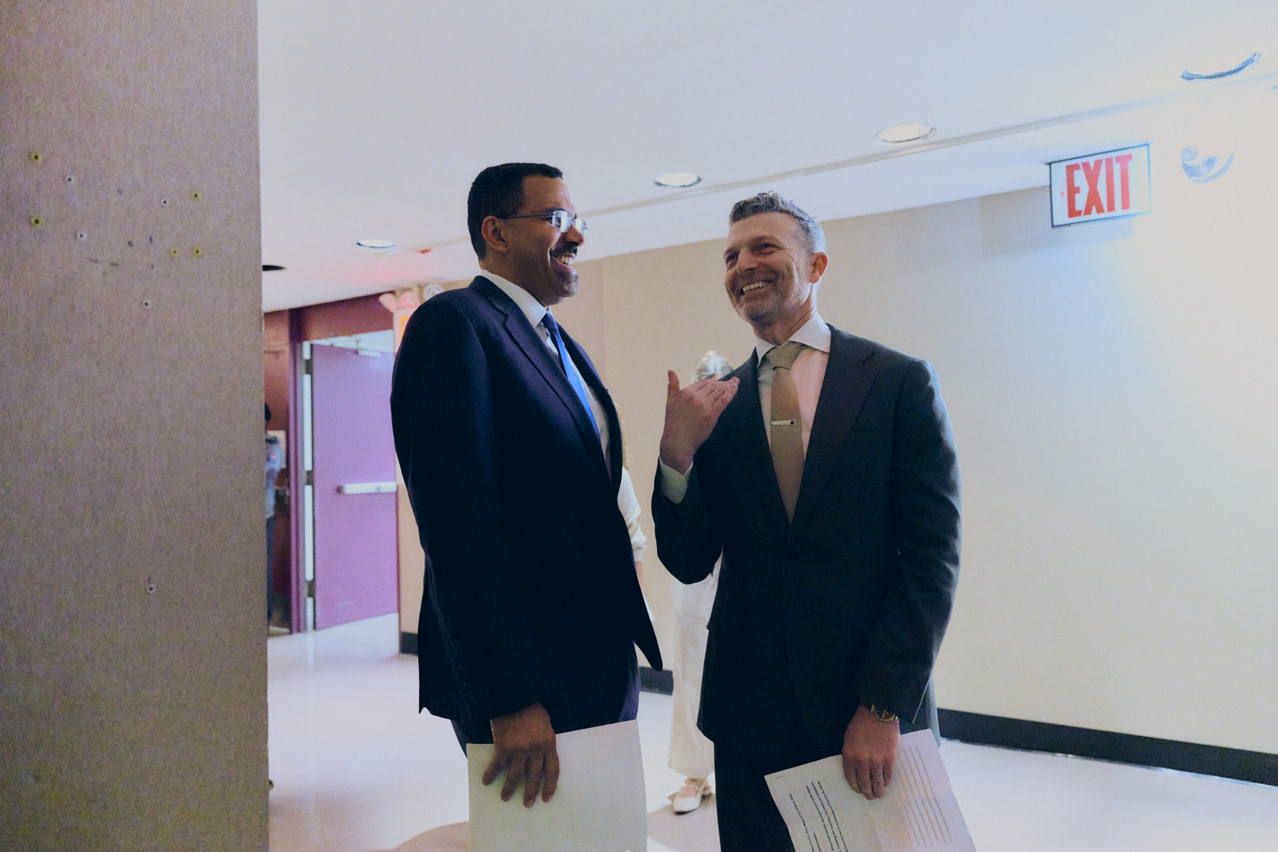 Two men speaking jovially