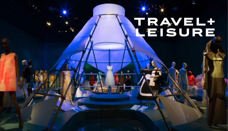 exhibition view of a show at The Museum at FIT; Travel and Leisure logo