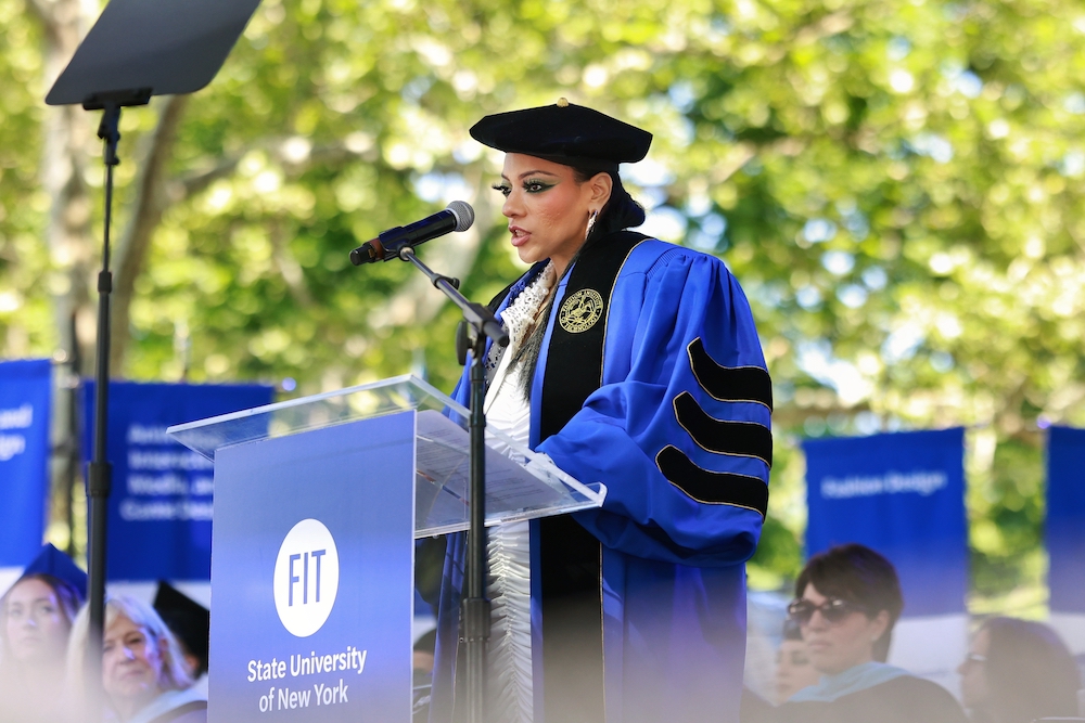 Abigail DeVille in regalia at the FIT commencement lecturn.