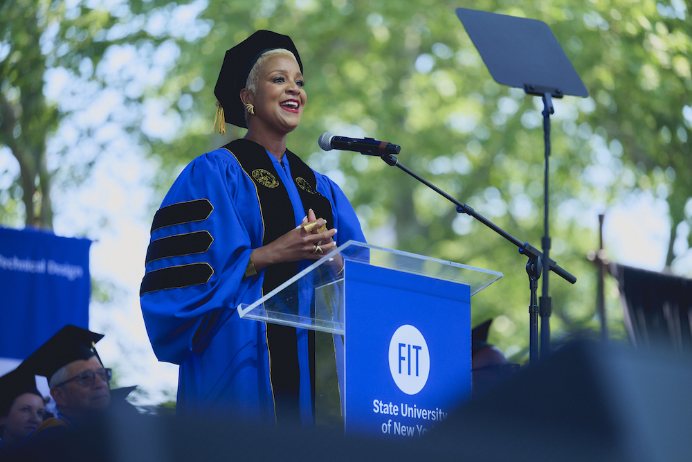Brandice Daniel in regalia at the FIT commencement lectern.