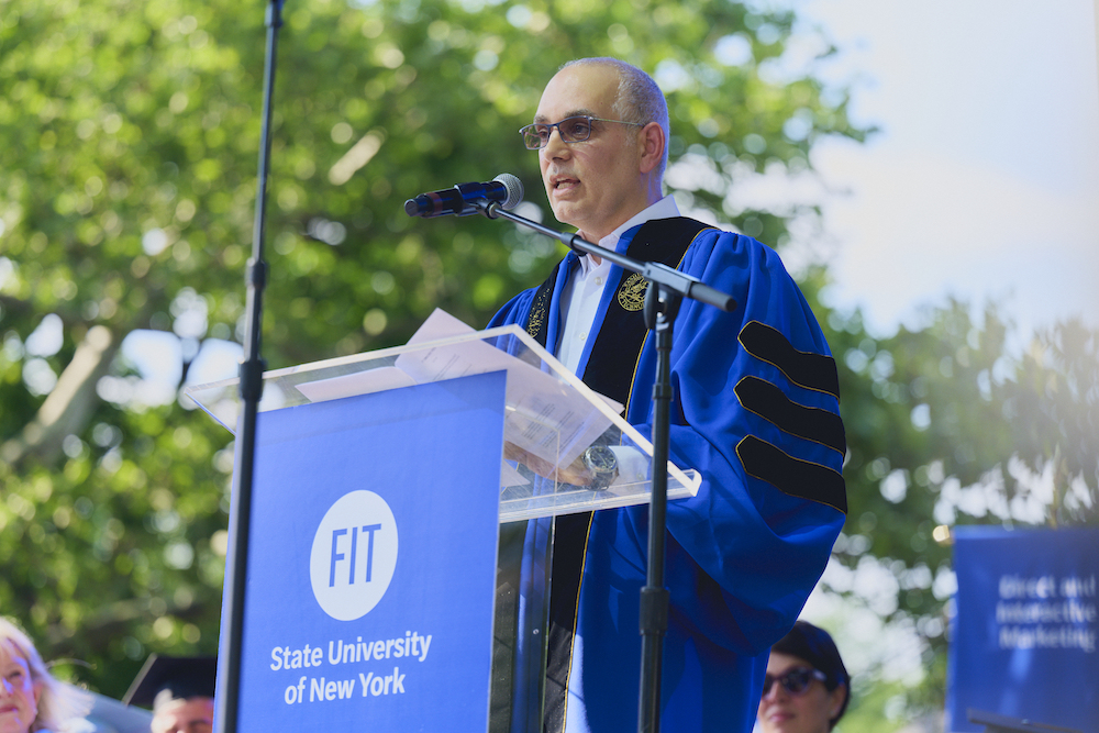 Chris Mazzilli in regalia at the FIT commencement lecturn.