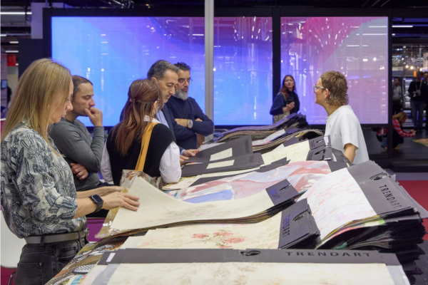 attendees at Heimtextil look at fabric samples