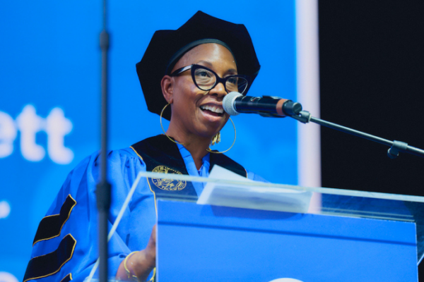 Malene Djenaba Barnett in regalia at the FIT commencement lecturn.