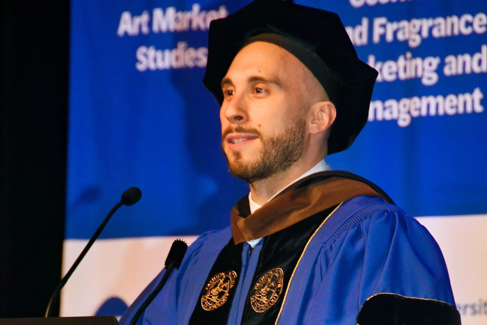 Robert Geronimo in regalia at the FIT School of Graduate Studies commencement lecturn.