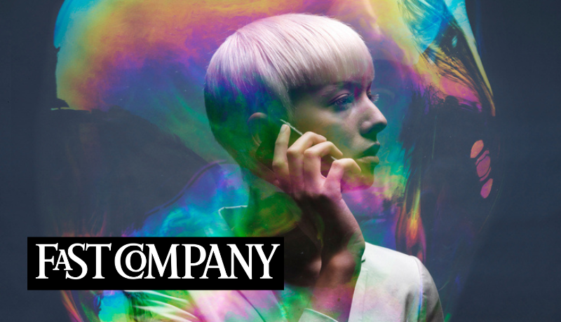 profile of short-haired woman with cellphone to head and bubble-like sheen around her; Fast Company logo 
