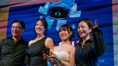 Faculty members celebrating with student award-winners on stage