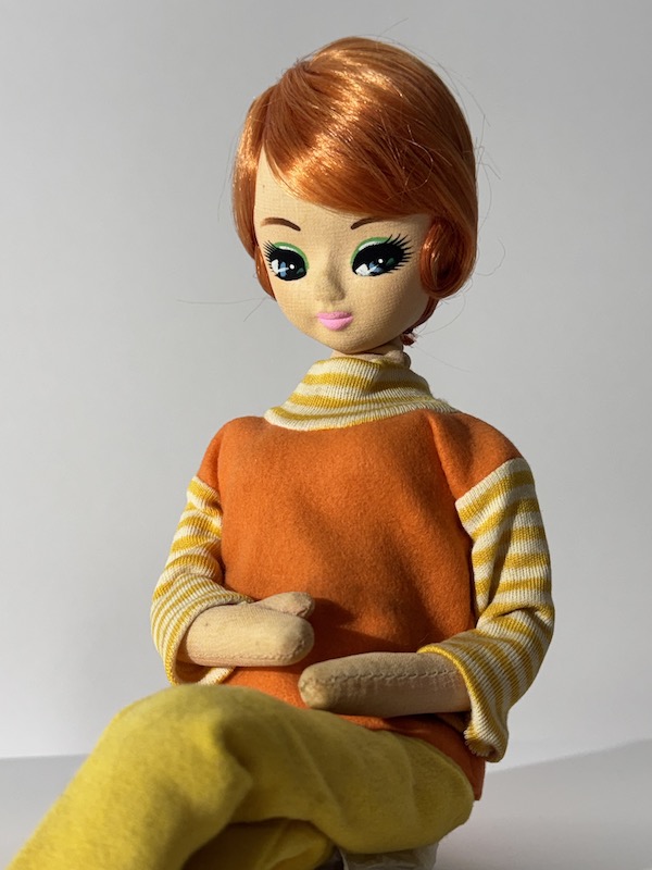 retro Barbie-style doll with short red hair