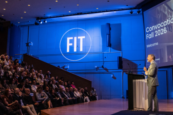 President Schupbach at a podium in front of an audience at convocation