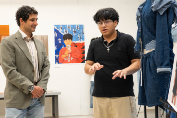A Precollege student discusses his painting with Zac Posen