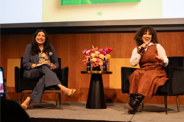 Elena Romero and Omi Hopper sit on stage in the Great Hall